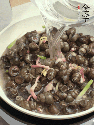 倒處理干凈的螺螄翻炒，加3勺料酒。加清水蓋過螺螄，中火蓋蓋煮5分鐘。